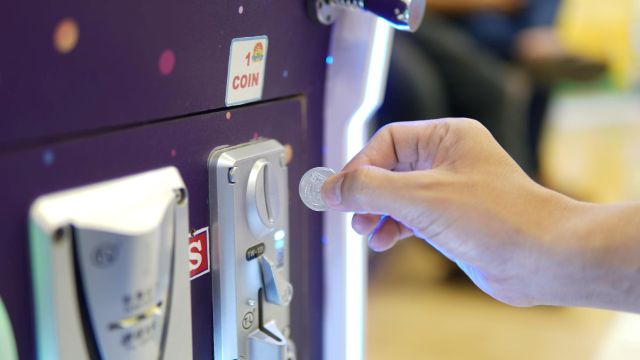 券売機にお金を入れる手